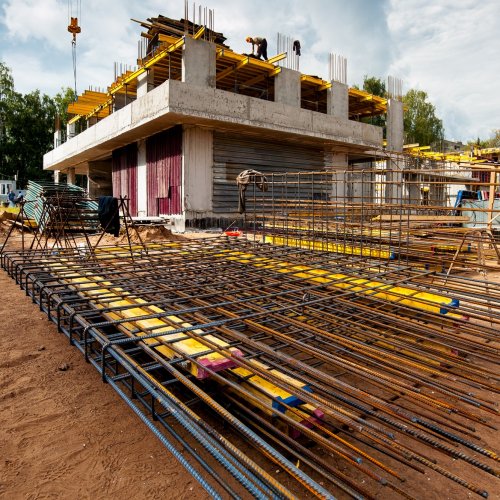 reinforced-frame-foreground-new-monolithic-house-construction-against-blue-sky