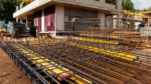 reinforced-frame-foreground-new-monolithic-house-construction-against-blue-sky